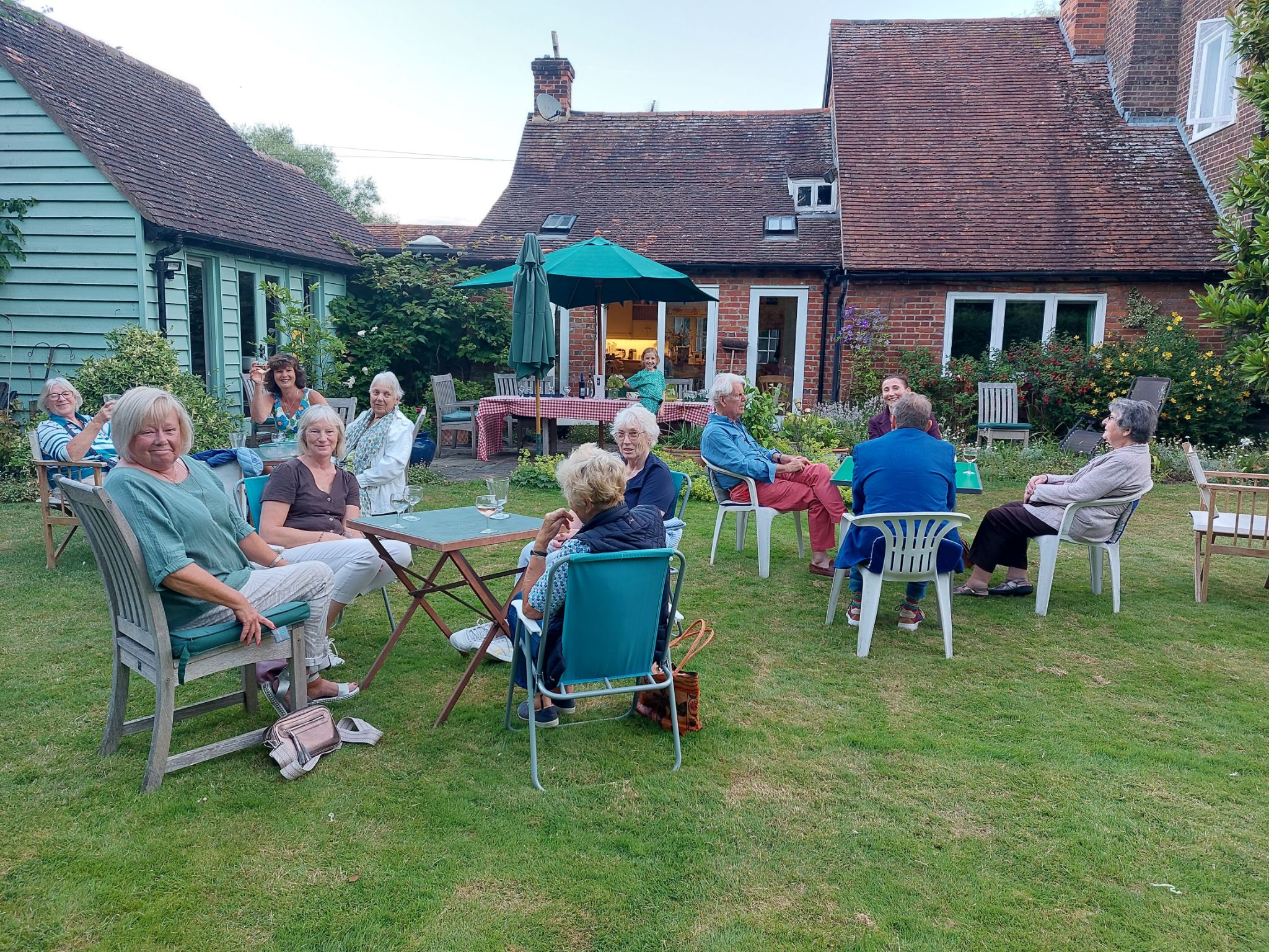 members of the mountfitchet garden club sitting int eh gardens at Thundridge Hill House